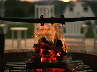 A cozy campfire surrounded by camping chairs.