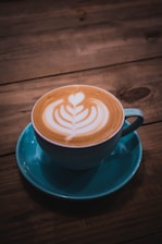 a cappuccino on a saucer on a wooden table