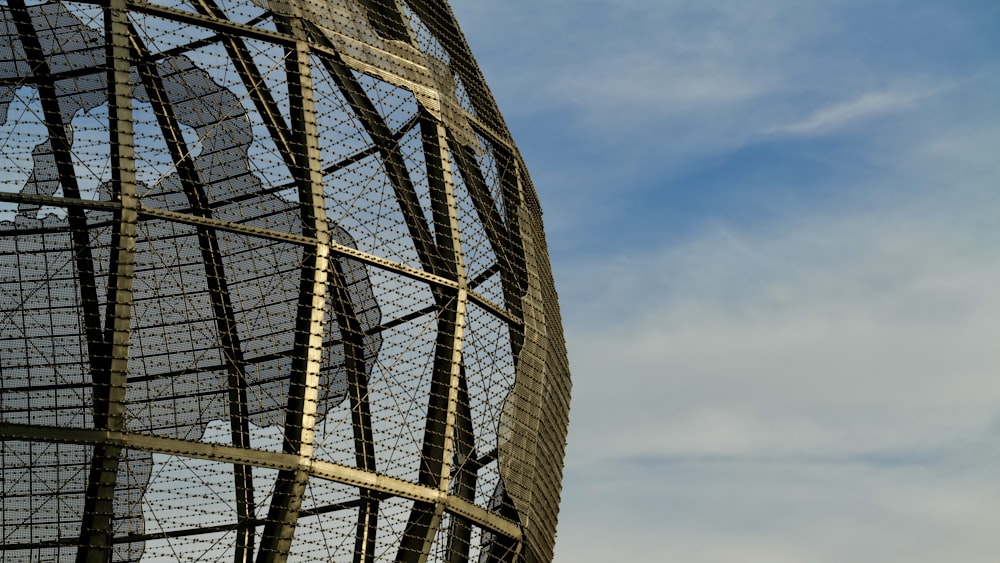 a large metal structure with a clock on top of it