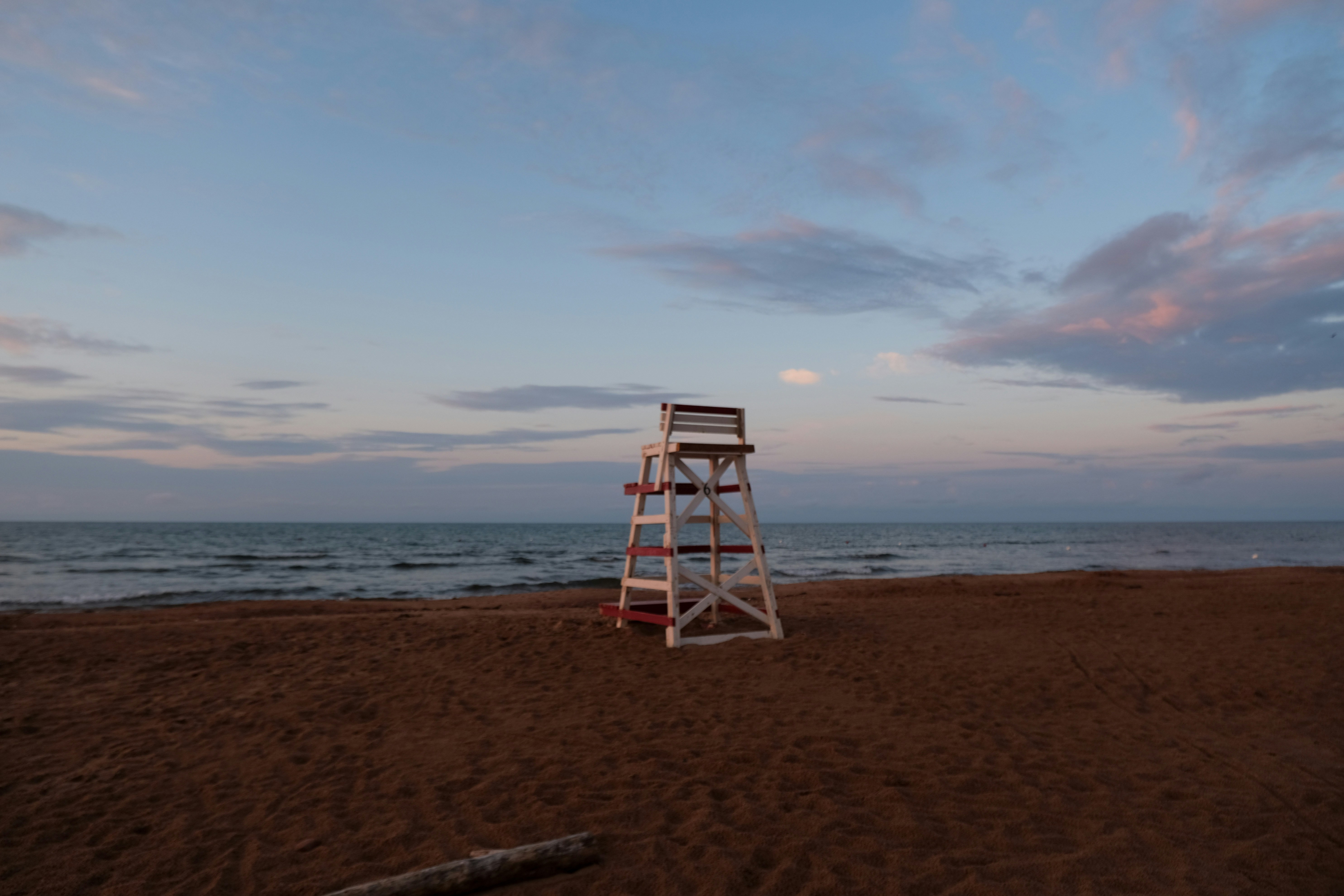 a lifeguard tower sitting on top of a sandy beach