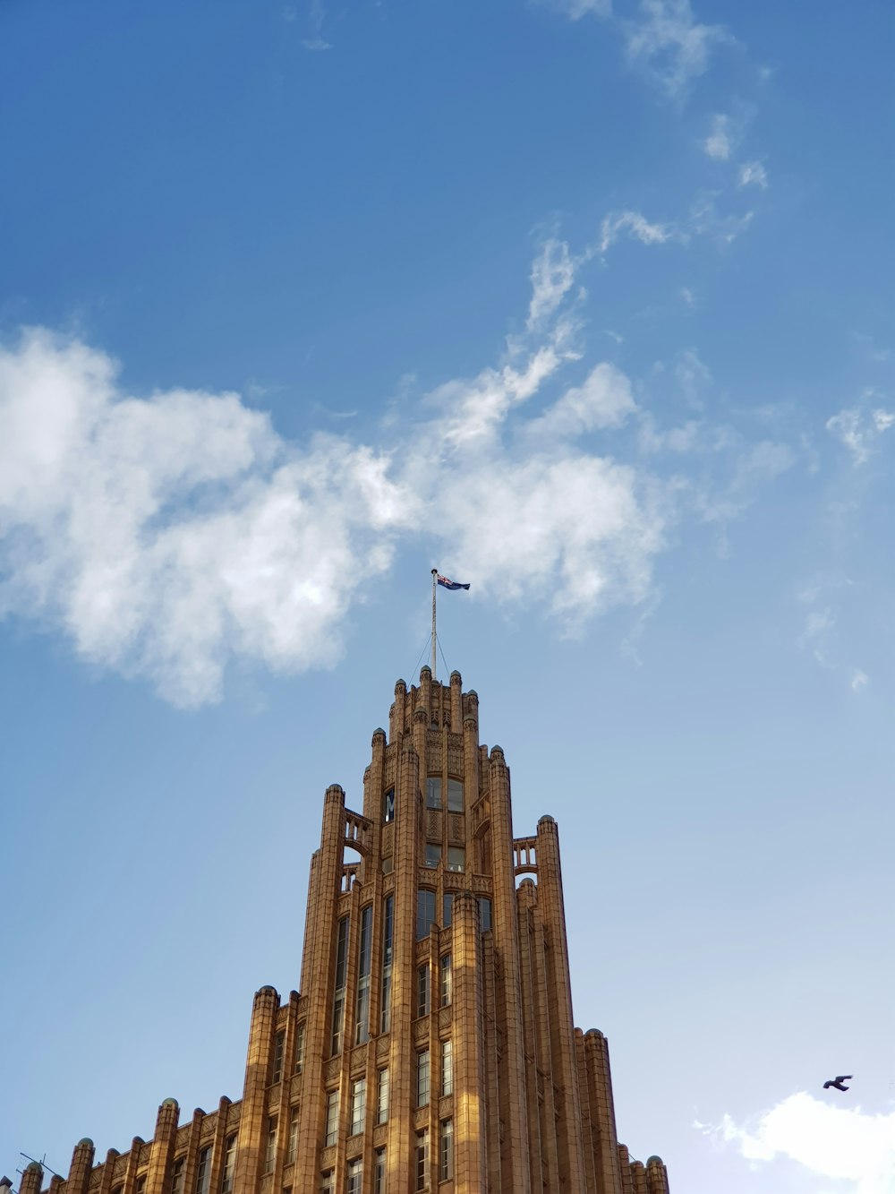 a tall building with a flag on top of it