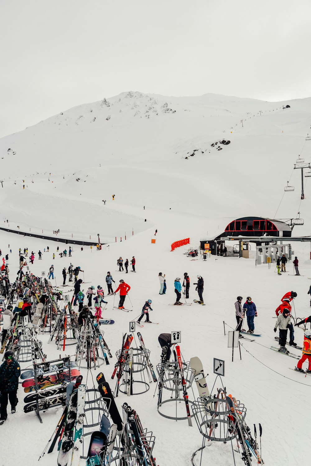 a large group of people standing on top of a snow covered slope