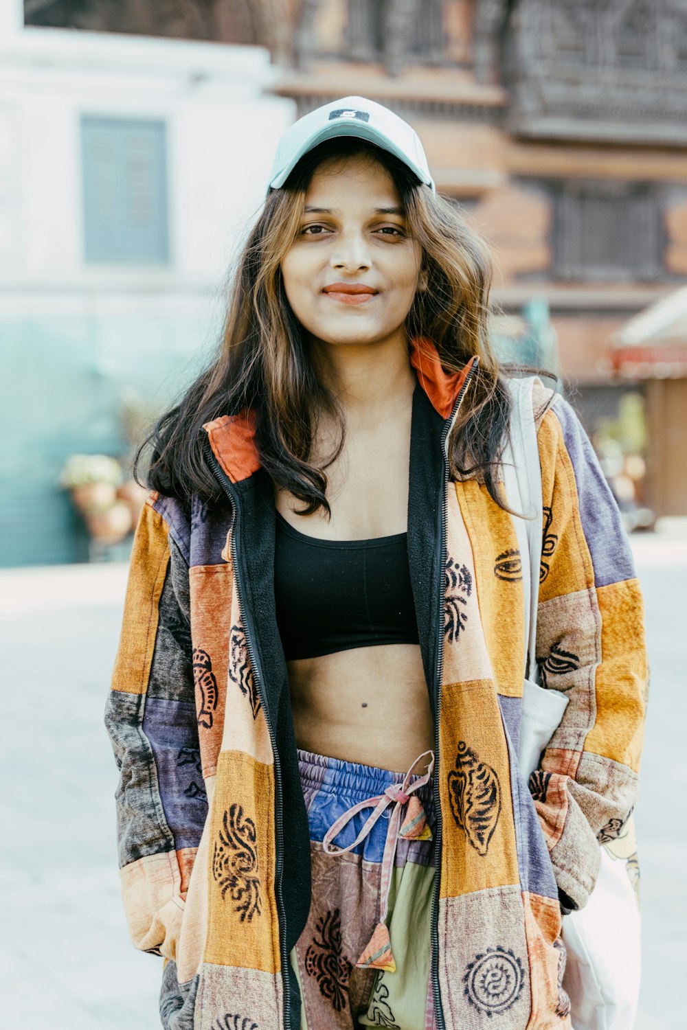 a woman with a baseball cap and a jacket