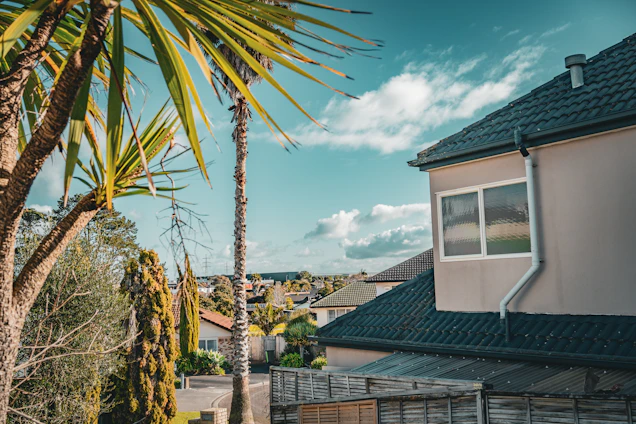 A friendly real estate agent showing a family a beautiful Subic home with a lush garden.