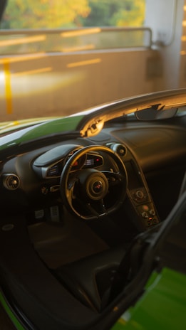 Close-up of a sleek racing simulator cockpit bathed in ambient warm lighting.