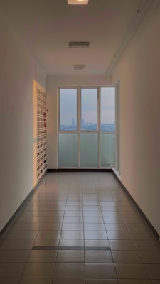 an empty room with a large window overlooking the city