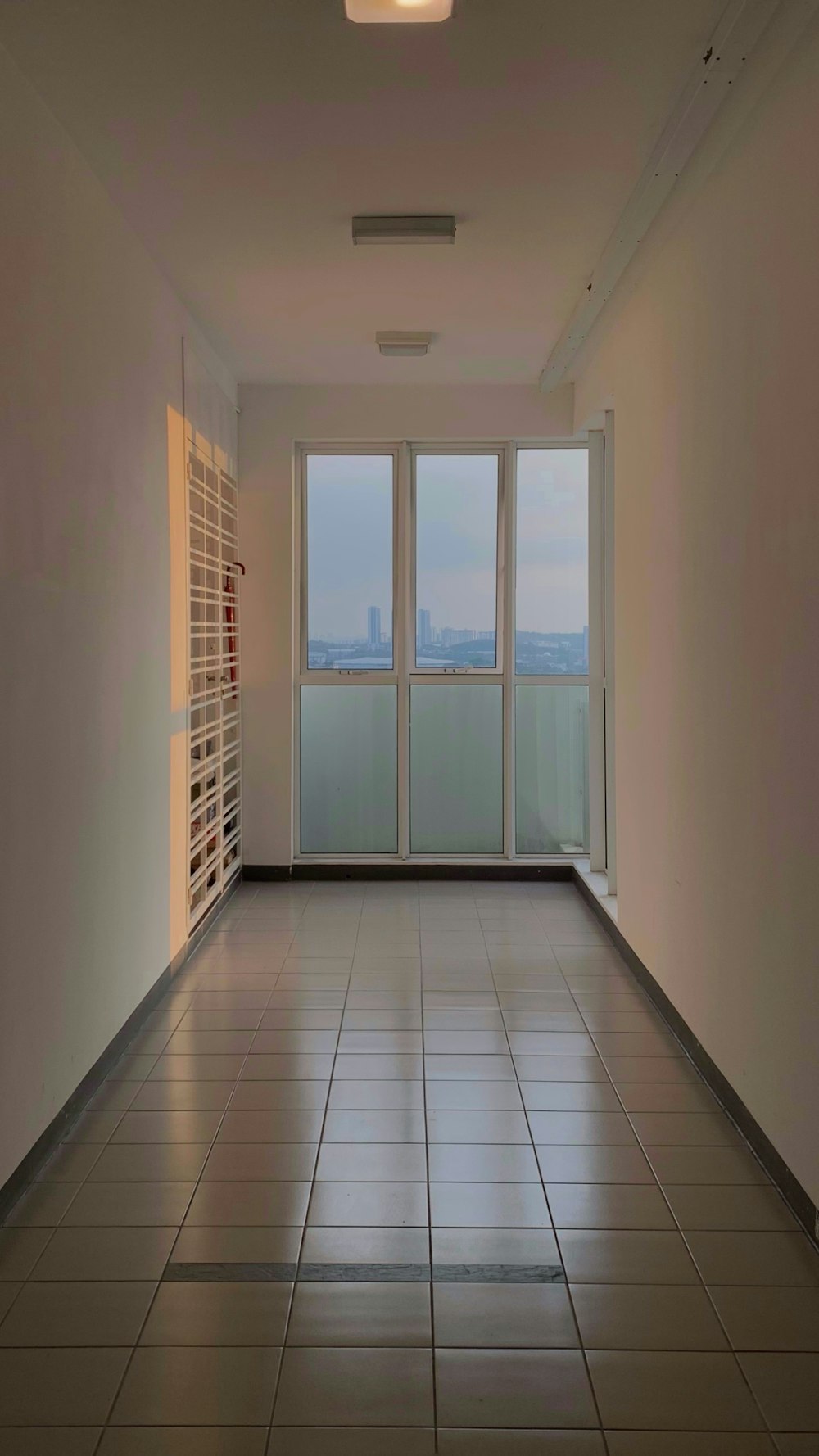 an empty room with a large window overlooking the city