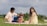 A smiling family enjoying a picnic in a sunny park, representing happiness and security.