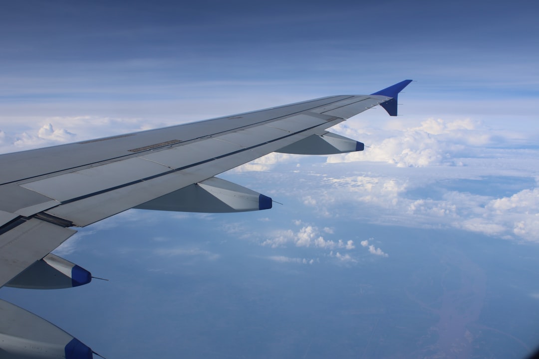 the wing of an airplane flying above the clouds,
