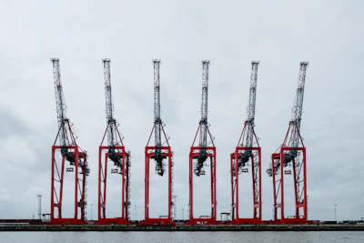 A fleet of heavy-duty cranes lined up ready for deployment.