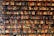 A vibrant display of various beverage bottles on a wooden shelf.