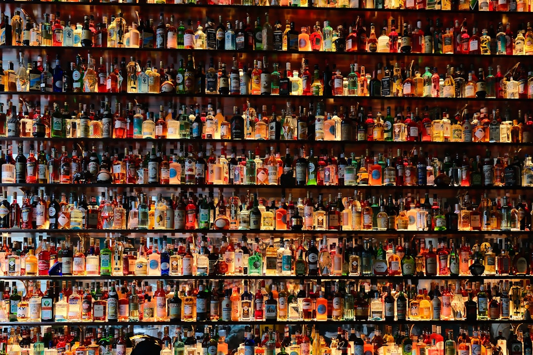 a wall full of bottles of liquor in a store