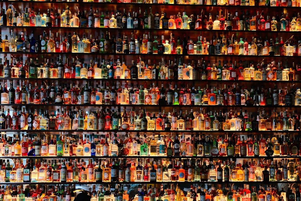 a wall full of bottles of liquor in a store