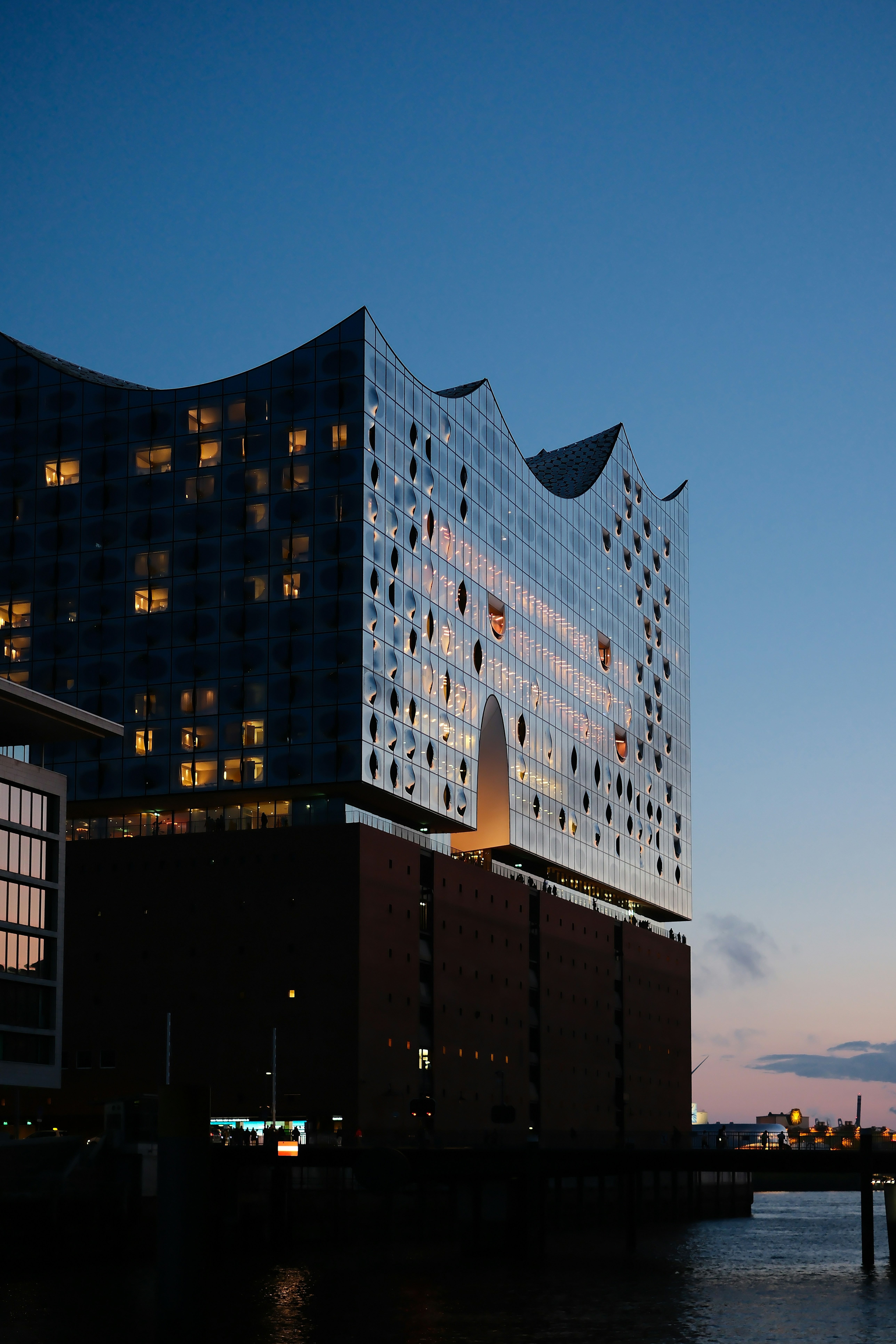a very tall building sitting next to a body of water