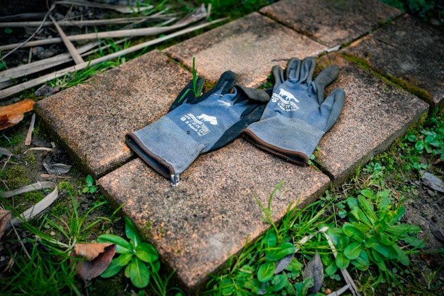 Comfortable padded cycling gloves laid out on a textured surface.