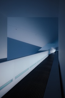 Minimalist hallway featuring wall-mounted lighting with clean design