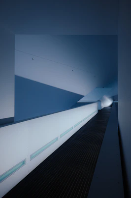 A sleek minimalist flush mount ceiling light brightening a modern hallway.