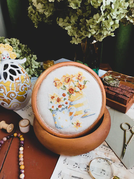 A cozy workspace with flower-themed bags, keychains, and art supplies scattered around.