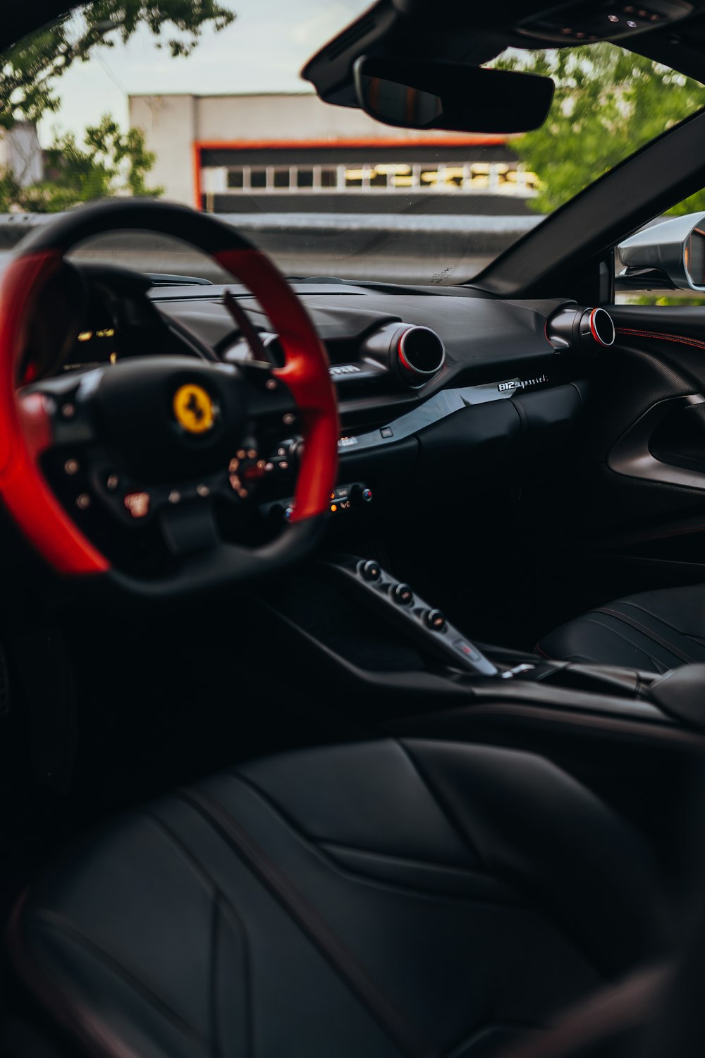 the interior of a car with a red steering wheel