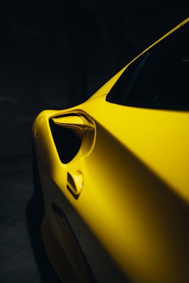 a close up of a yellow sports car