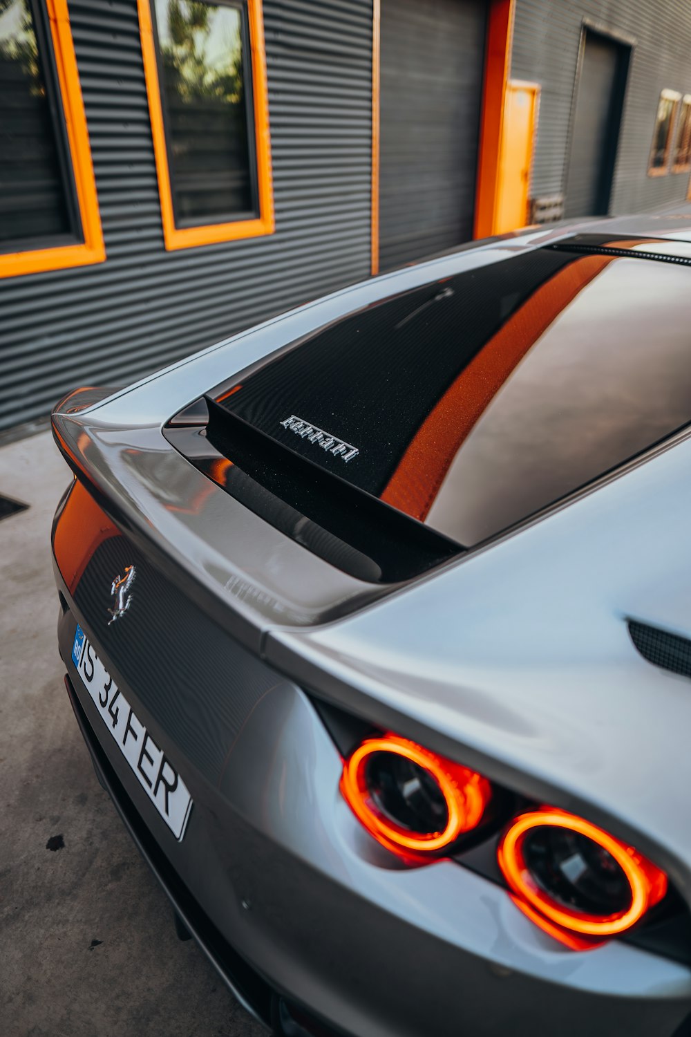 a silver sports car parked in front of a building