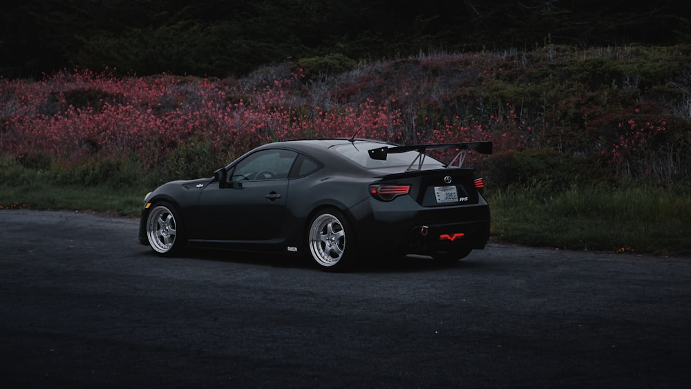 a black sports car parked on the side of the road