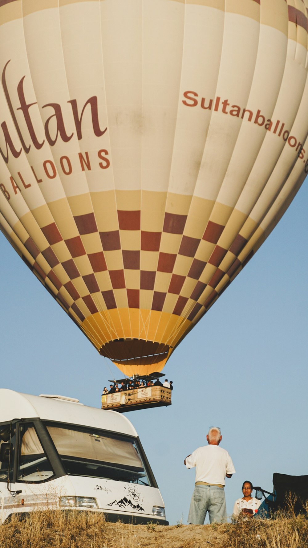 a group of people standing next to a hot air balloon