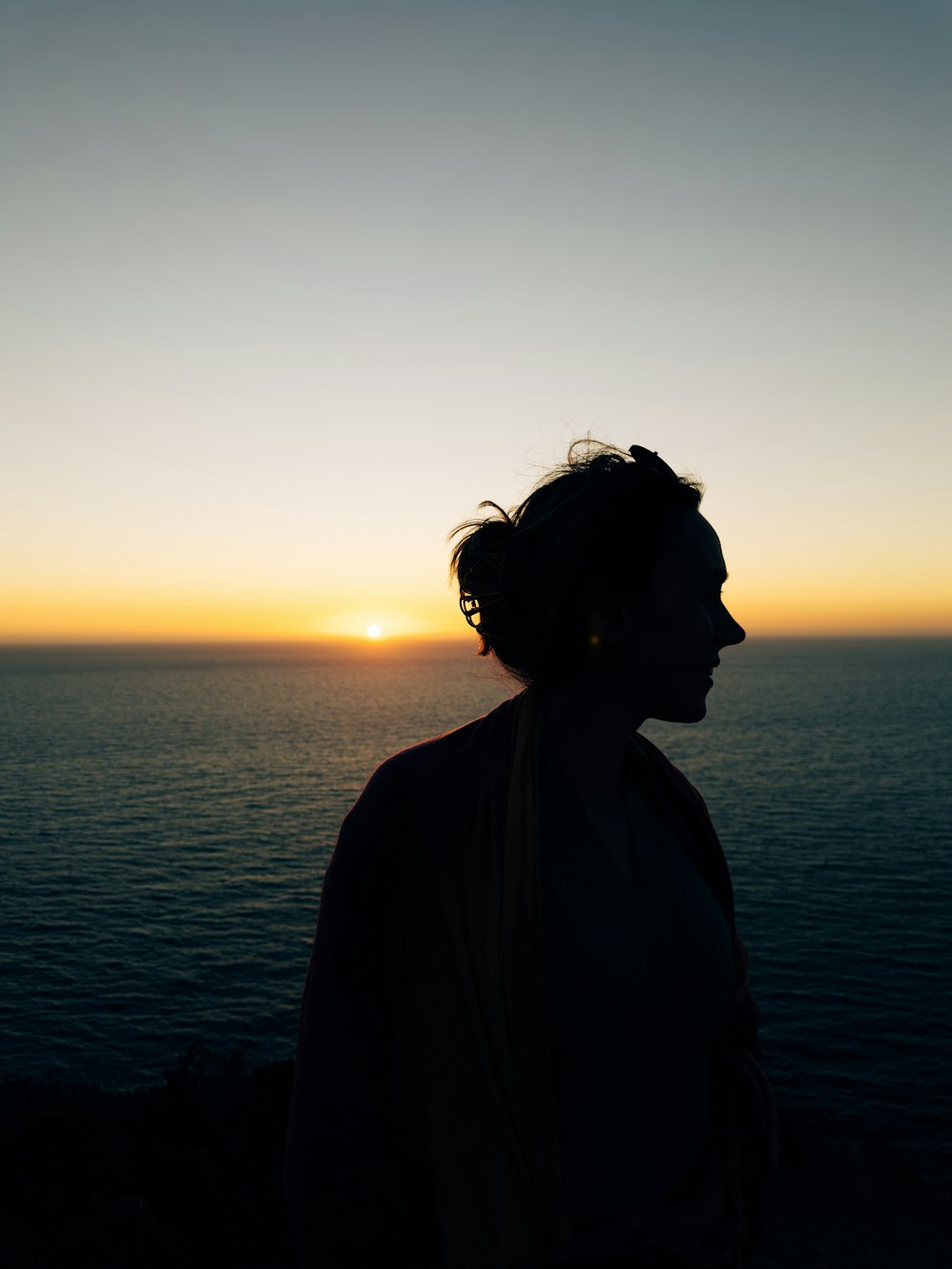 a person standing in front of a body of water