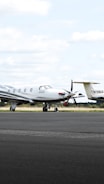 A Boeing small private jet parked on a runway ready for boarding.