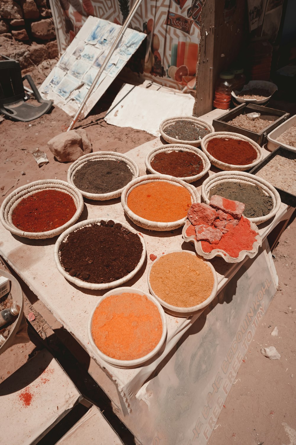a table topped with bowls filled with different colored spices