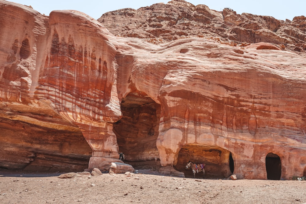 a group of people standing inside of a cave