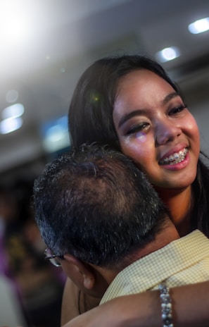 A happy family embracing after a dental checkup at San Clemente Smiles LLC
