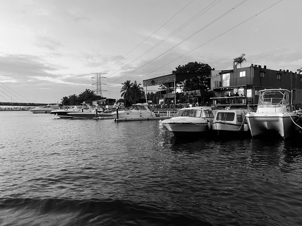 a black and white photo of boats docked in a harbor