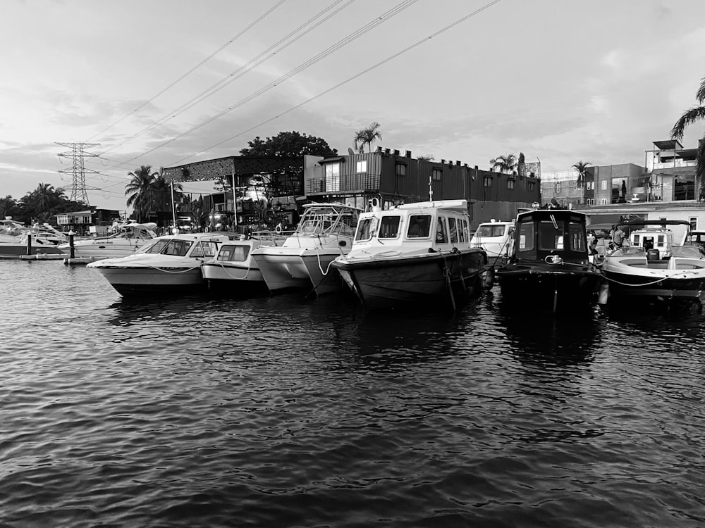 a black and white photo of several boats in the water