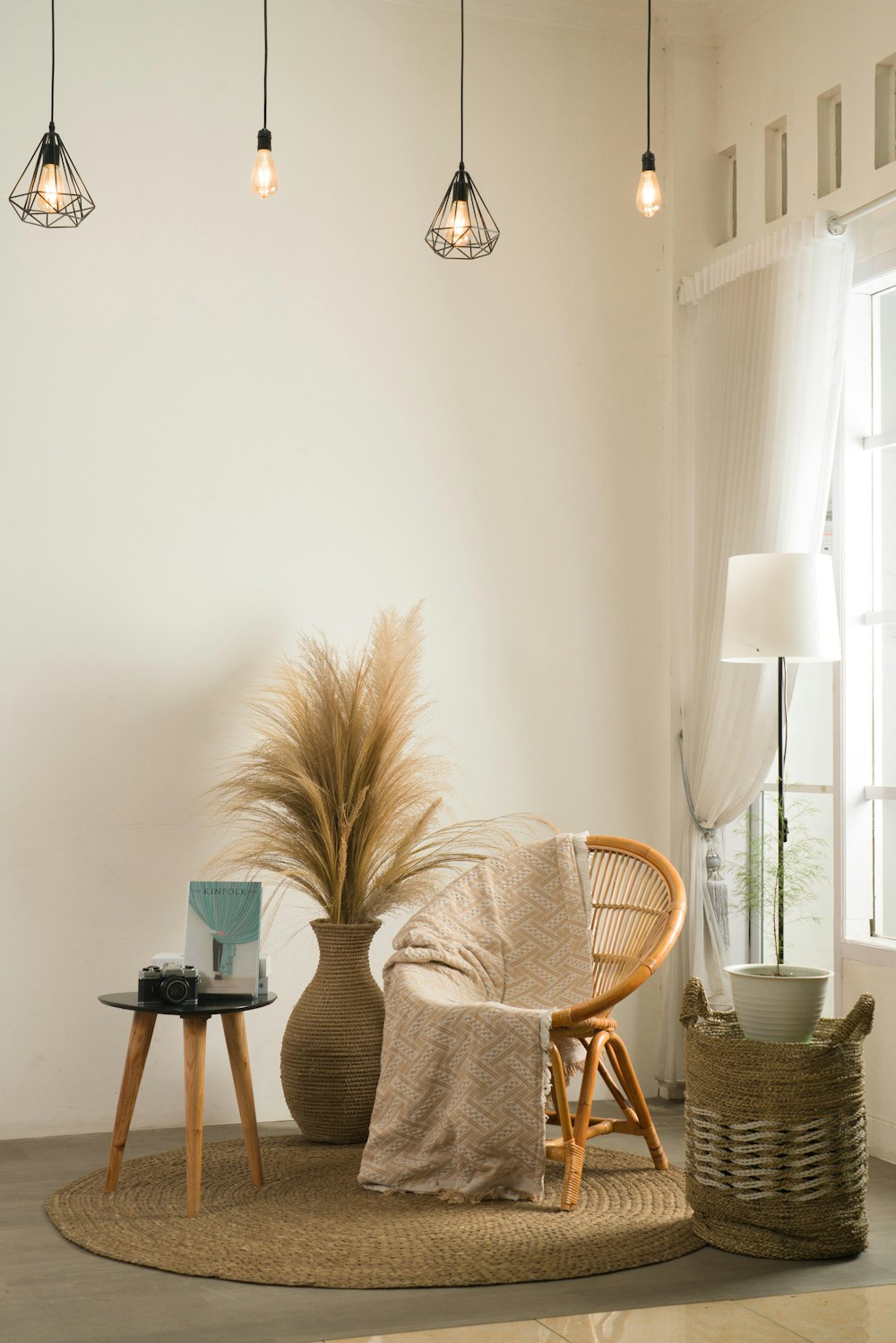 a living room with a chair, table and a potted plant