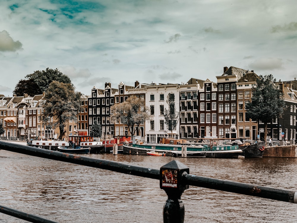 a view of a river with buildings and a parking meter in the foreground