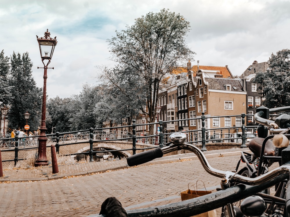 a bicycle parked on the side of a brick road