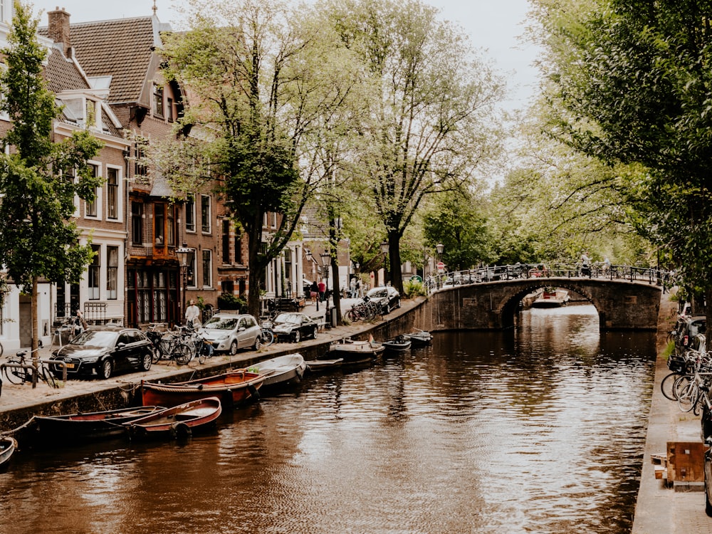 a canal with boats and bicycles parked along it