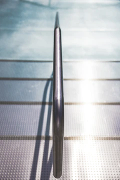 Close-up image of a stainless steel handrail with a modern, polished finish.