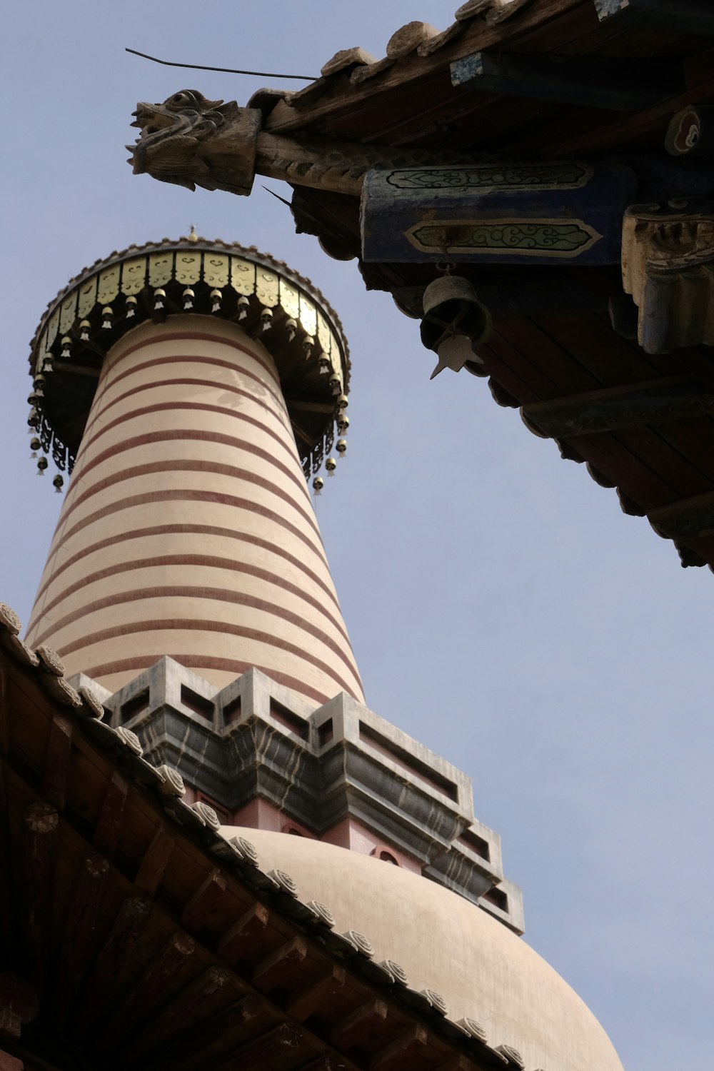 a very tall tower with a clock on it's side