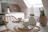 A cozy kitchen table set with colorful stoneware plates and bowls glowing in natural light.