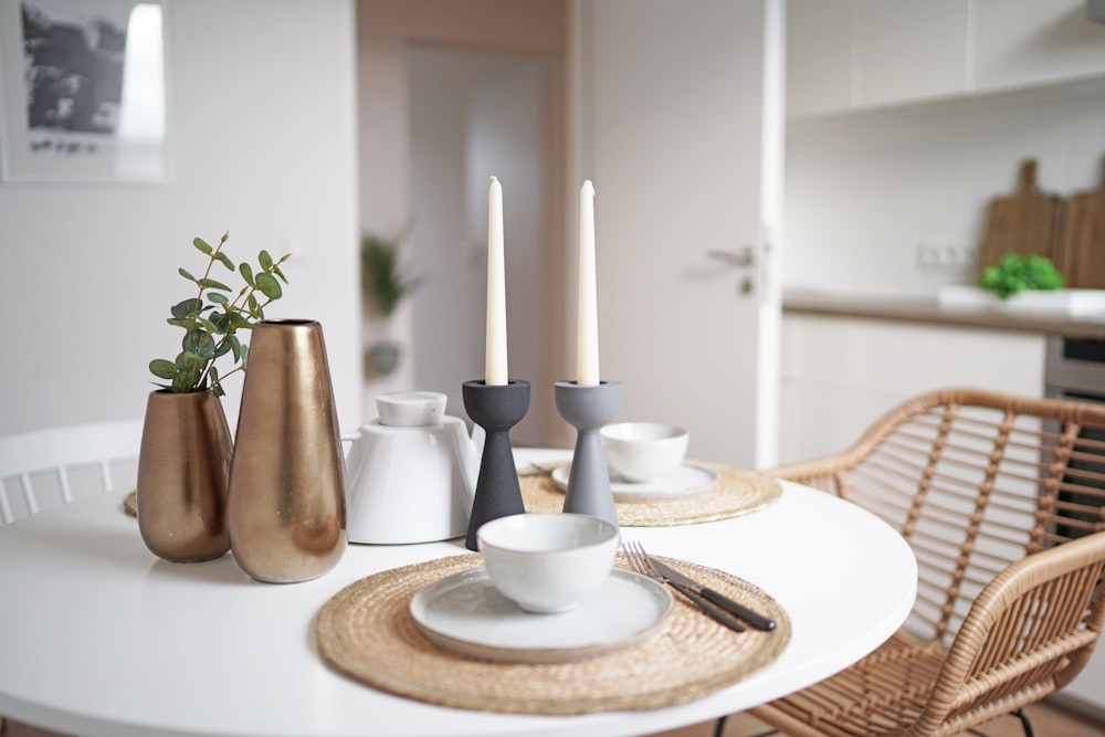 a white table topped with plates and cups