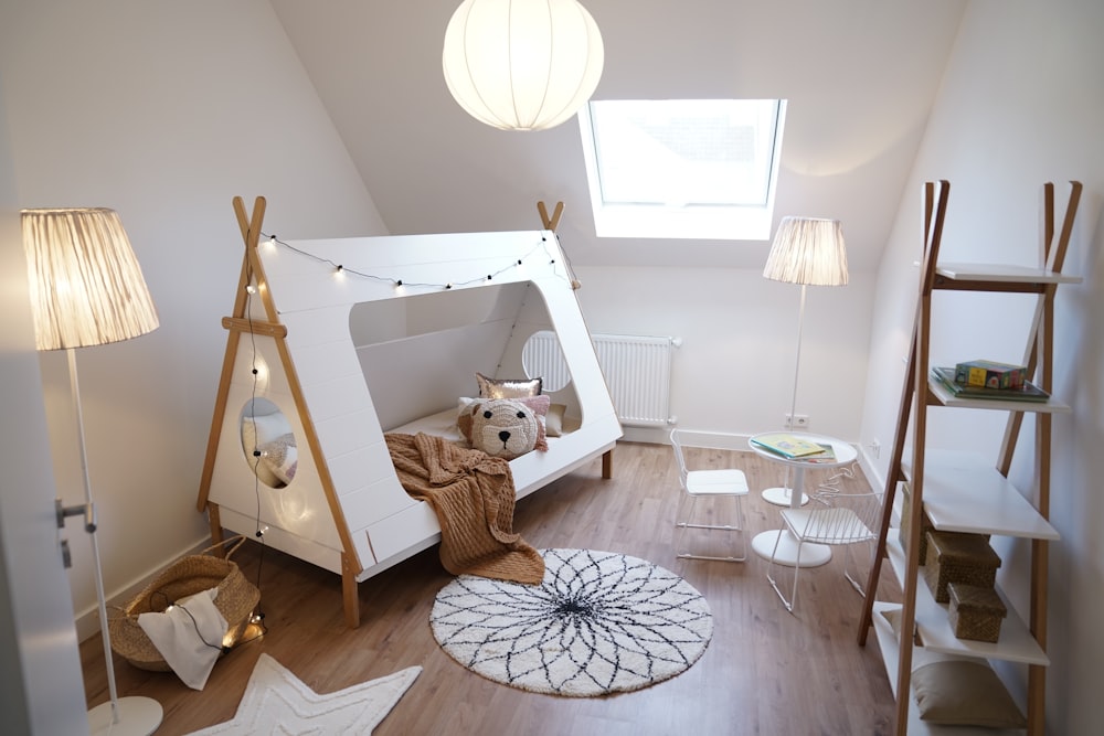 a child's room with a teepee tent and a bed