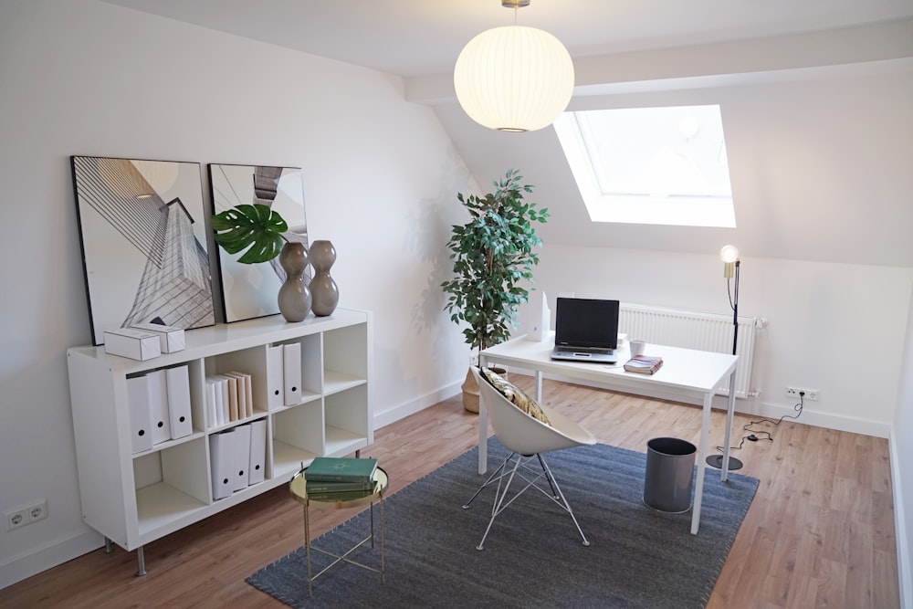 a living room with a couch, chair, table and bookshelf