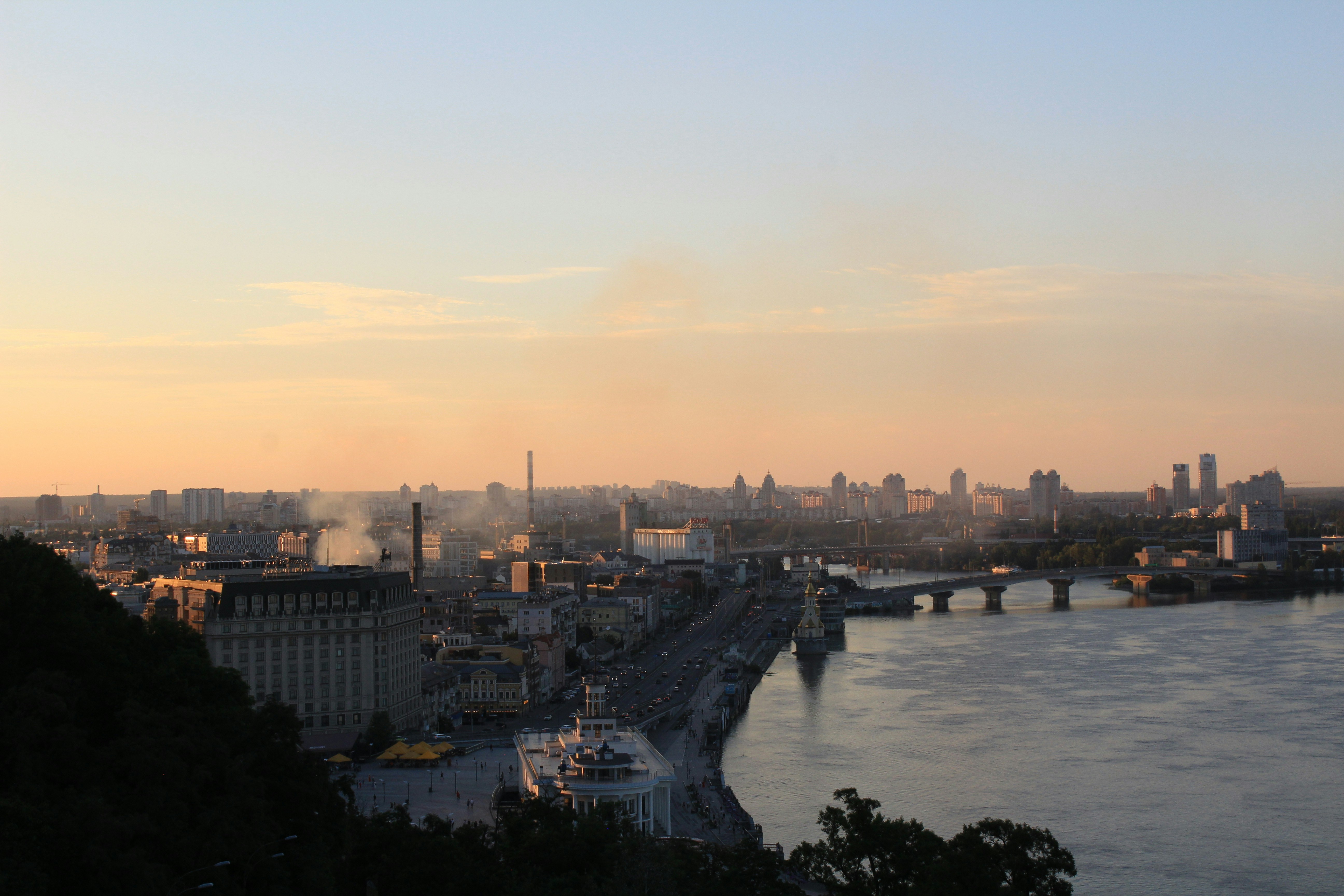 a view of a city and a river at sunset