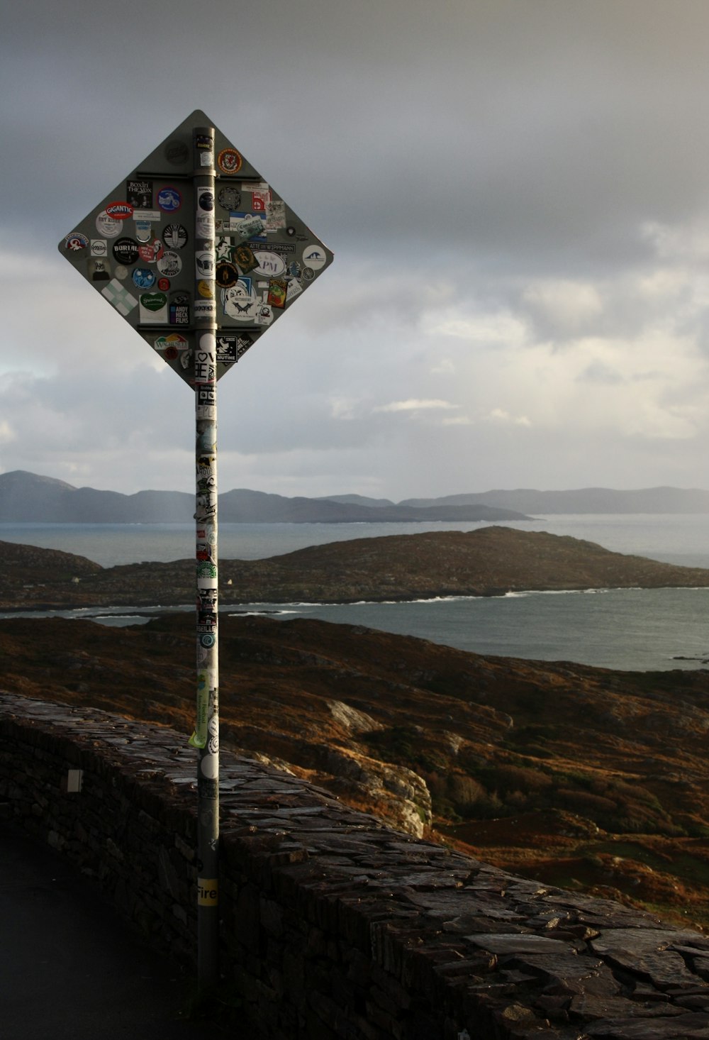 a street sign with a lot of stickers on it