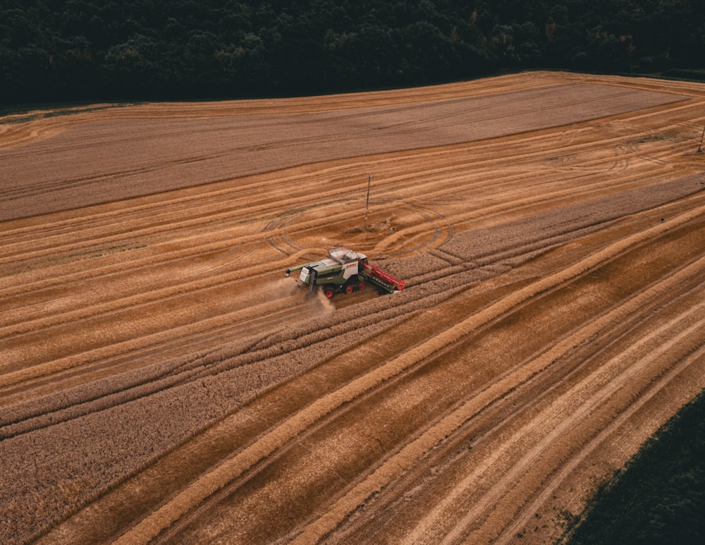 a tractor is plowing a field of crops