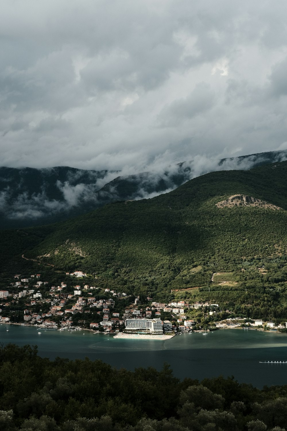 a large body of water surrounded by a lush green hillside