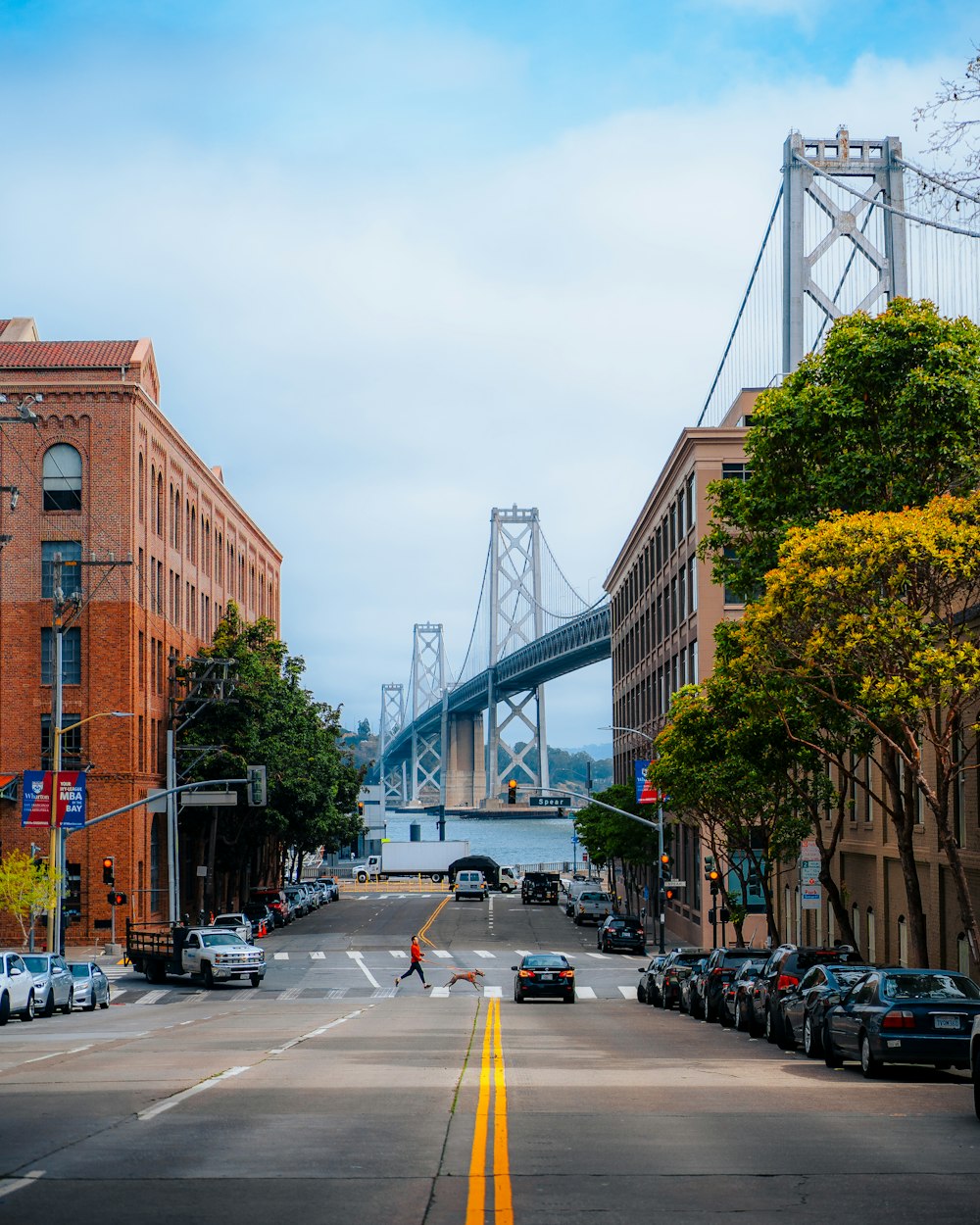 a city street with a bridge in the background