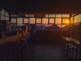 Sunset terrace with warm golden light and a cozy coffee setup overlooking Monumentha Next.